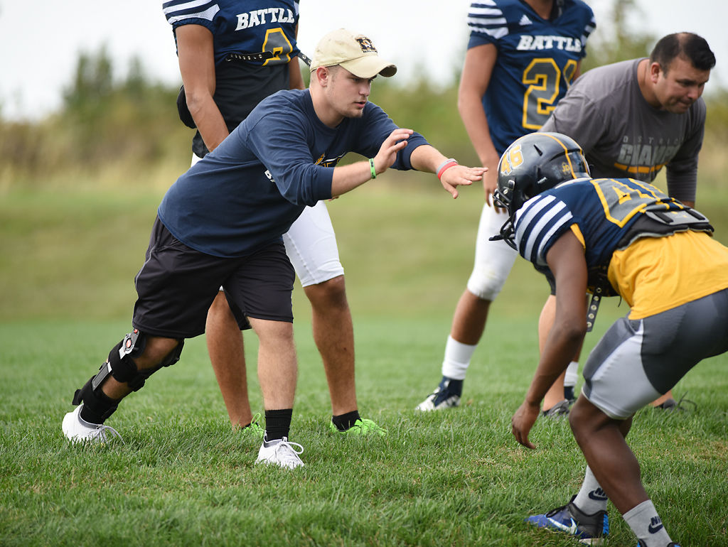 Cody Rachatellelle helps Battle High School defensive back Mahzeen Cross